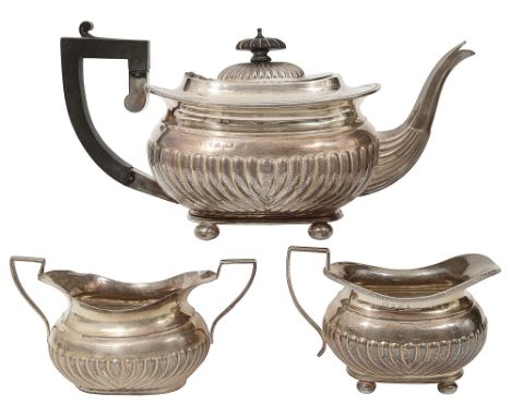 A late Victorian matched three piece silver tea servicethe teapot and cream jug Birmingham, 1901/1902, makers mark rubbed, th