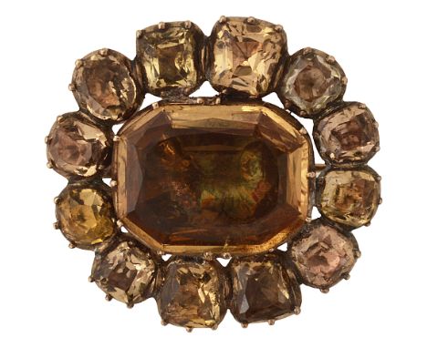 A Georgian topaz and yellow gold cluster brooch, the central octagonal topaz within a surround of cushion-shaped topaz, cut d