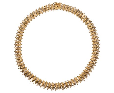 A fancy link necklace, composed of a rosette and arrow head link, each applied to a mesh backing, the clasp stamped '750lengt