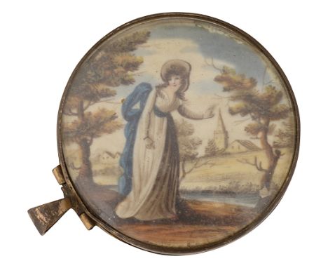 A Georgian circular gilt locketcontaining an ivory vignette of a pastoral landscape with a young lady standing in the foregro