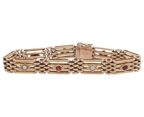 A early 20th century 9ct yellow gold gate line bracelet, each of the nine links alternately set with a half pearl or a garnet