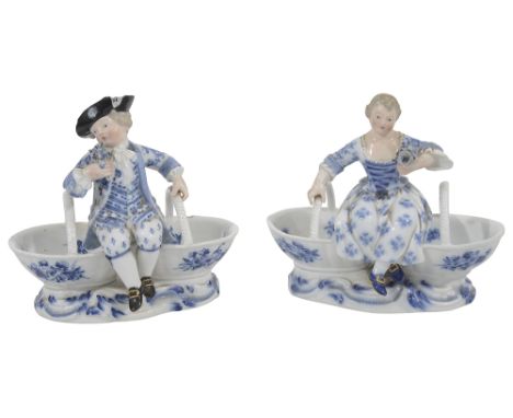 A pair of late 19th century Meissen figural double table saltsmodelled as a boy and girl in 18th century dress seated on conj