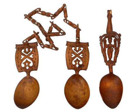 A pair of 19th century Norwegian treen birchwood wedding spoons with chain and a carved Russian spoonfirst of traditional des