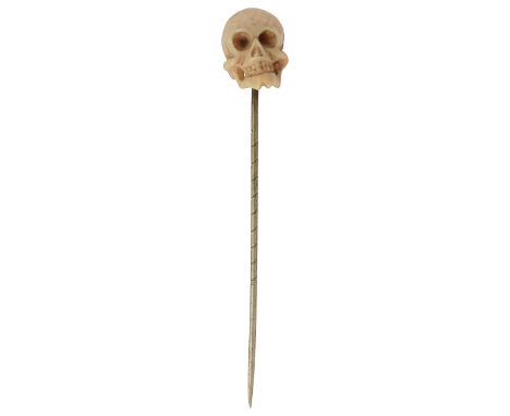 An unusual coral stick pin in the form of a scull finely carved and contained in fitted caselength of head approx 1.5cmCondit