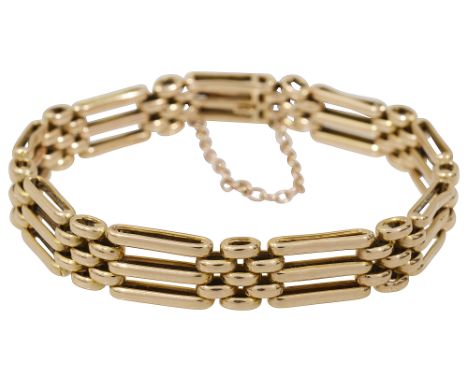 A 15ct gold gate braceletthe three bar bracelet with safety chain stamped on the push clasp fastening 15ctweight approx 13gCo
