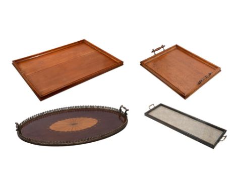 A late 19th century plum pudding mahogany and marquetry inlaid oval tray in George III style and three other traysinlaid with