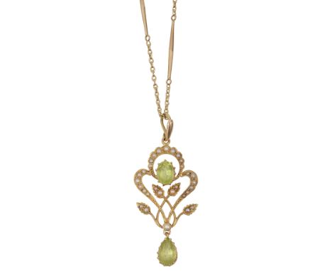 An Edwardian 15ct peridot and seed pearl pendant on chainthe ribbons, scrolls and leaves inset with seed pearls with oval fac