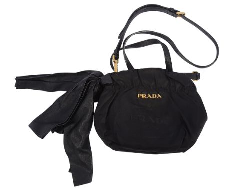 A Prada Tessuto bow crossbody bagfeaturing a nylon body bearing gold toned hardware Prada log and a leather bow, with adjusta