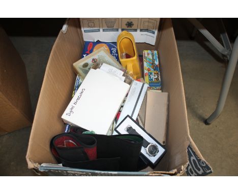 A box containing various items to include beer mats, Guinness wrist watch, digital binoculars, games etc.