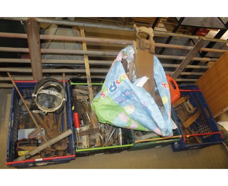 Four boxes containing a large quantity of tools including welders mask, pipe wrench, battery charger, clamp, various spanners