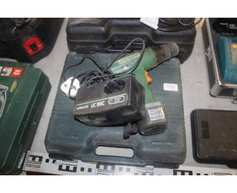 A Hitachi cordless electric drill in fitted plastic case with instruction guide & battery charger
