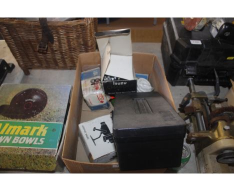 A box containing a tool chest of various fishing floats, lures, accessories, an Isuzu charger X-1 fishing reel with original 