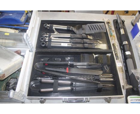A barbecue utensil set in fitted metal case