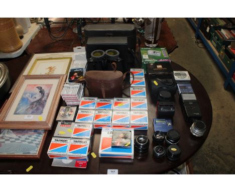 A collection of various camera lenses; Tamron custom mounts; a pair of binoculars and binocular cases etc.