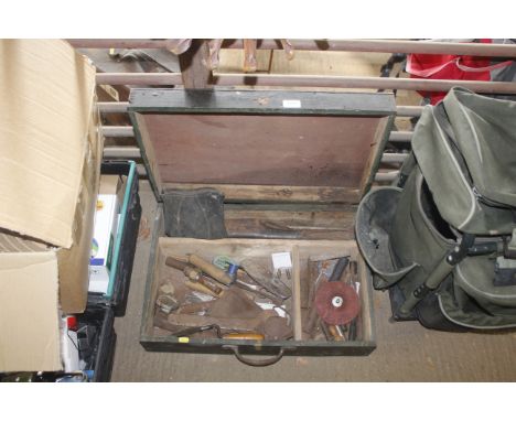 A wooden tool box containing a quantity of various hand tools including spanner, long nose pilers etc 