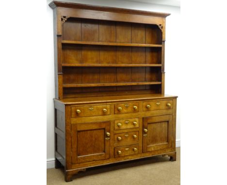 19th century oak dresser, projecting conrice, three shelf plate rack, two short and four long drawers, two cupboard doors, sh