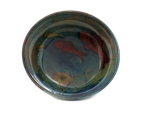 A Moorcroft pottery flambe bowl,decorated with fish in a seascape, two of the fish with flambe glaze,16.5cm diameter6.5cm hig