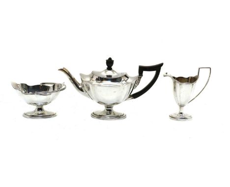 A silver three piece tea service,by Thomas Bradbury &amp; Sons Ltd, London 1904 and 1911, comprising a teapot, 26cm wide, a c