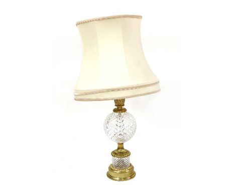 A Waterford crystal glass table lamp, the globular diamond cut body, enclosed by gilt metal mounts, 58.5cm high to fitting 97