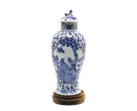 A Chinese blue and white vase and cover,Guangxu (1871-1908), of baluster form, painted with two bulbuls standing on a rock be