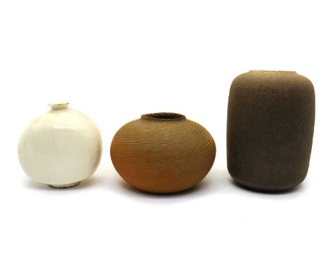 Three Japanese pottery vases,20th century, comprising a cylindrical vase in dark brown, plain, 25.5cm high, a white-glazed mo