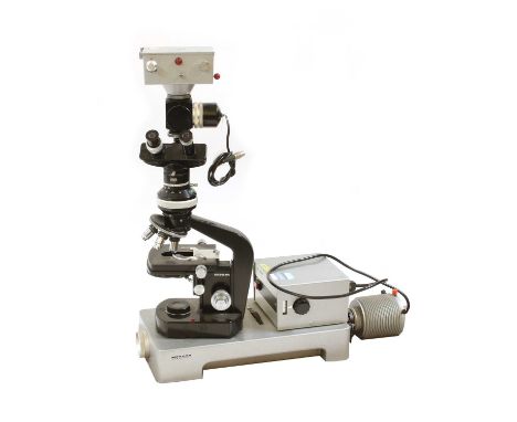 A Wild Heerbrugg Ltd. M20 microscope and accessories, including Universal Lamp, 3 x Phasenkontrast boxes, a Zeichentubus box,