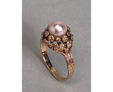 9ct Gold ring set with a single Pearl on a raised floral setting with bark effect to shoulders size approx 'L' and 2.7g