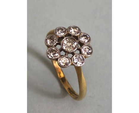 18ct yellow gold ring with 9 diamonds in a platinum setting of wheel design approximately size T and 2.99g