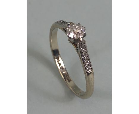 Platinum and diamond set ring with central Diamond enhanced bi diamond set shoulders approx size 'L' 