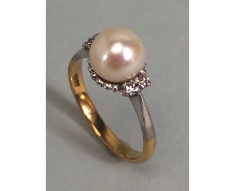 18ct Gold and platinum ring set with a large Pearl and with twin diamond shoulders (the pearl approx 7.7mm in diameter) size 
