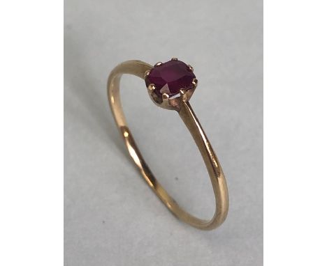Gold coloured unmarked ring set with faceted pale ruby size approx 'Q' 