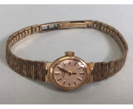 9ct Gold ladies Rotary watch (weight without mechanism 12g) on 9ct gold bark effect fully hallmarked strap. Winds sets and ru