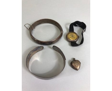 Silver items to include silver bangles, a silver heart shaped pendant and a vintage silver cased watch (4)