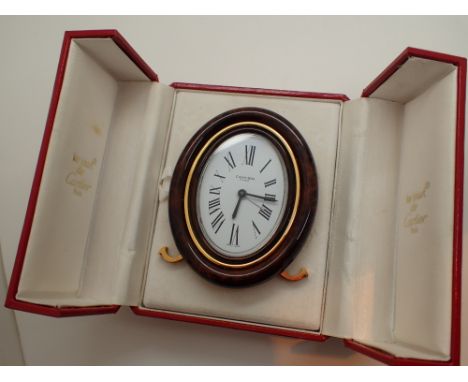 Boxed Must De Cartier mechanical alarm clock boxed with papers CONDITION REPORT: P&P to UK address: £15 + VAT.The foldown han