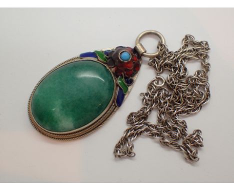 Large cabochon jade pendant set with enamelled flowers in a hallmarked Chinese silver mount with hallmarked sterling silver c