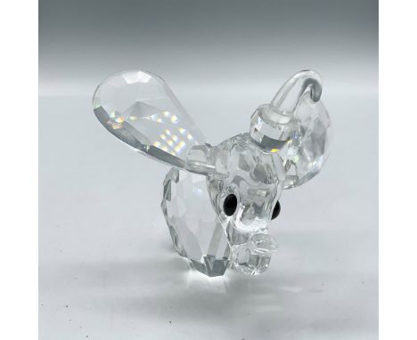 Clear crystal figure with large ears, black crystal eyes, trunk raised and frosted crystal tail wearing his hat. Swarovski ba