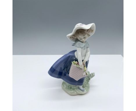 Glossy figure of an adorable little girl with a basket of flowers. Lladro backstamp. This item has its original box (4.75"L x