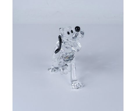 A clear Pluto standing joyfully with one paw raised and a smile on his face, decorated with white and black crystals for his 