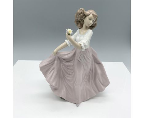 Glossy figure of a woman holding her skirt and a flower. Lladro backstamp. This item has its original box (9.25"L x 8"W x 13.