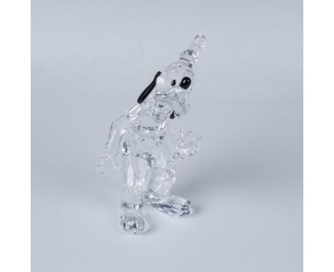 A clear Goofy gently waving with a cheerful smile, featuring black and white crystals for his eyes, ears, and nose. Swarovski