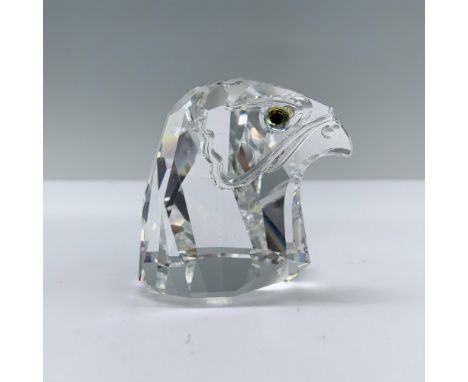 The head of a falcon with a narrow facet around the face, showcasing melon colored eyes. Swarovski backstamp. Swarovski backs