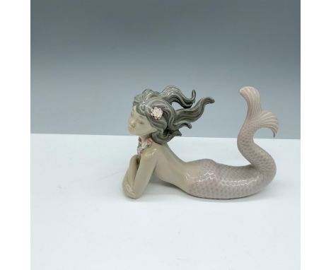 Glossy figure of a serene mermaid donning a floral necklace. Lladro backstamp. This item has a base included (5.75"L x 2.5"W 