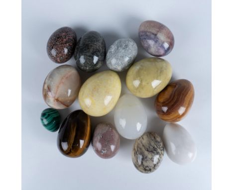 Beautiful collection of polished mineral eggs, each showcasing the unique colors, patterns, and textures of various natural s