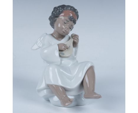 Glossy figure of a divine being sitting on a cloud and playing an instrument. Lladro backstamp. This item has its original bo