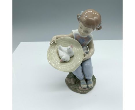 Glossy figure of a little girl finding some birds in her hat. Lladro backstamp. This item has its original box (5.5"L x 5.5"W