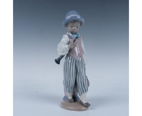 Glossy figure of a musician holding his bag and his instrument. Lladro backstamp. This item has its original box (5.75"L x 4.