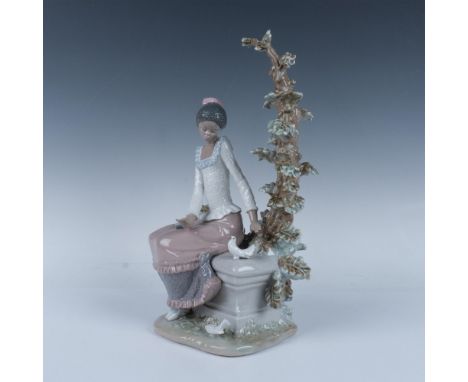 Glossy endearing figure of a woman ready to read by a tree, in the company of two lovely doves. Lladro backstamp. This item h