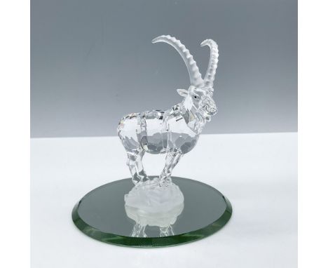 Beautiful clear crystal with frosted horns standing on a rocky frosted base. Completed by jet black eyes. Alongside a circula