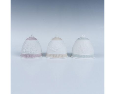 3 matte finished bells of a Christmas theme for the years 1987, 1989, and 1992. Lladro backstamp. Each item has its original 