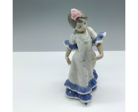 Glossy figure of a young lady showing off her exquisite dance moves. Lladro backstamp. This item has its original box. Box di